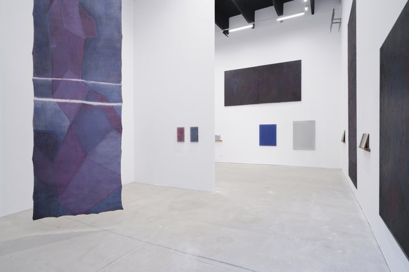 Headnotes - Curated by Schumacher and Hoyos; Almost Chair, 2012, handbrushed steel, 80 × 40 cm; Bigger than—Red Blue No 3, 2023, acrylic on canvas, 148 × 419 cm; Bigger than—Monochrome No6, 2025, oil on canvas, 197 × 412 cm; Bigger than—Monochrome No5, 2024, oil on canvas, 220 × 470 cm; Standing with a Painting No12, 2025, ink and oil on plexiglas and wood, 45 × 27 cm; Standing with a Painting No11, 2025, ink and oil on plexiglas and wood, 45 × 27 cm; Easel Painting—Blue No5, 2025, oil on canvas, 110 × 90 cm; Easel Painting—White No4, 2023, oil on canvas, 137 × 103 cm — installation view, Headnotes, Suprainfinit Gallery, 2025